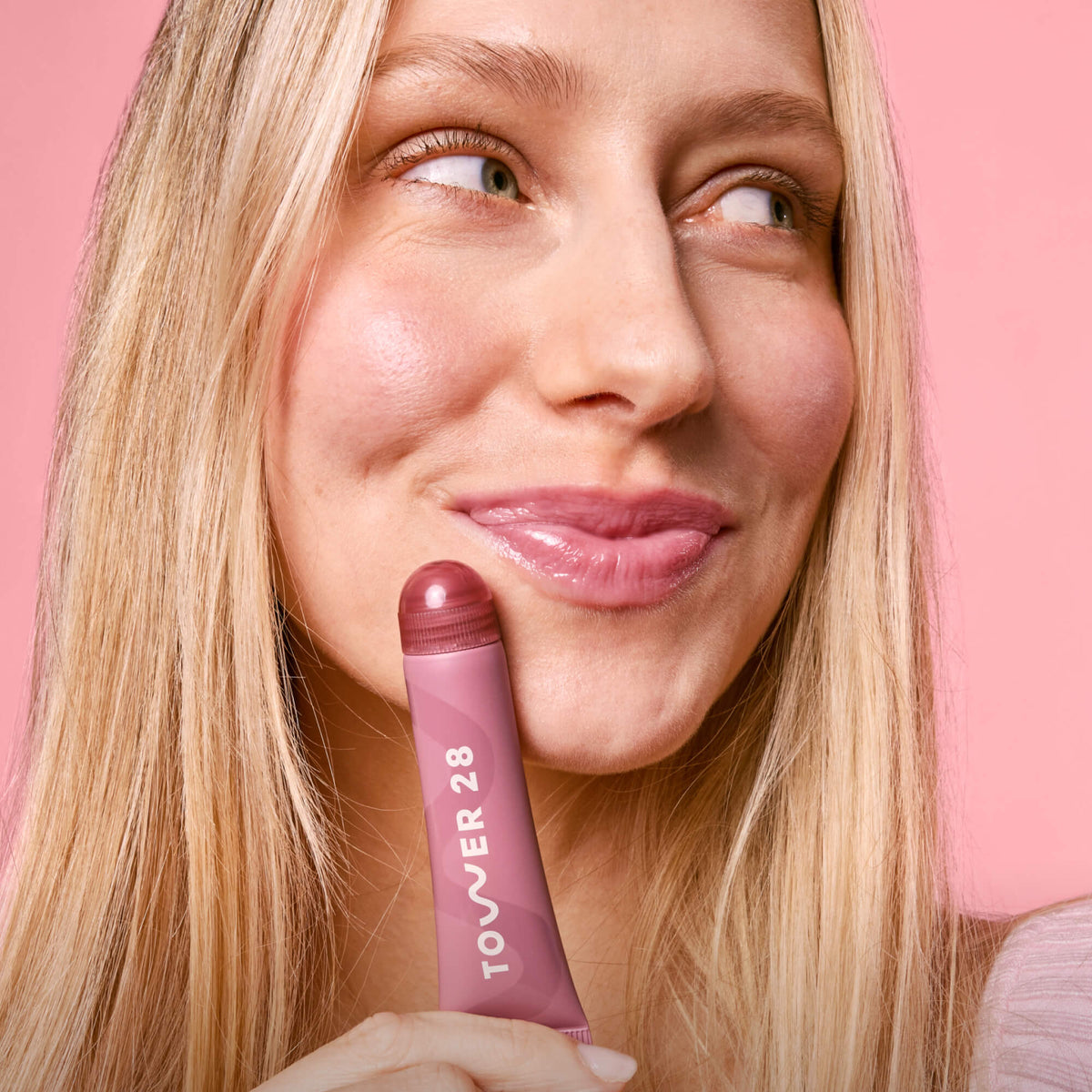 Tower 28 Beauty's LipSoftie® Lip Treatment in Sugar Plum applied on model. [Sugar Plum]