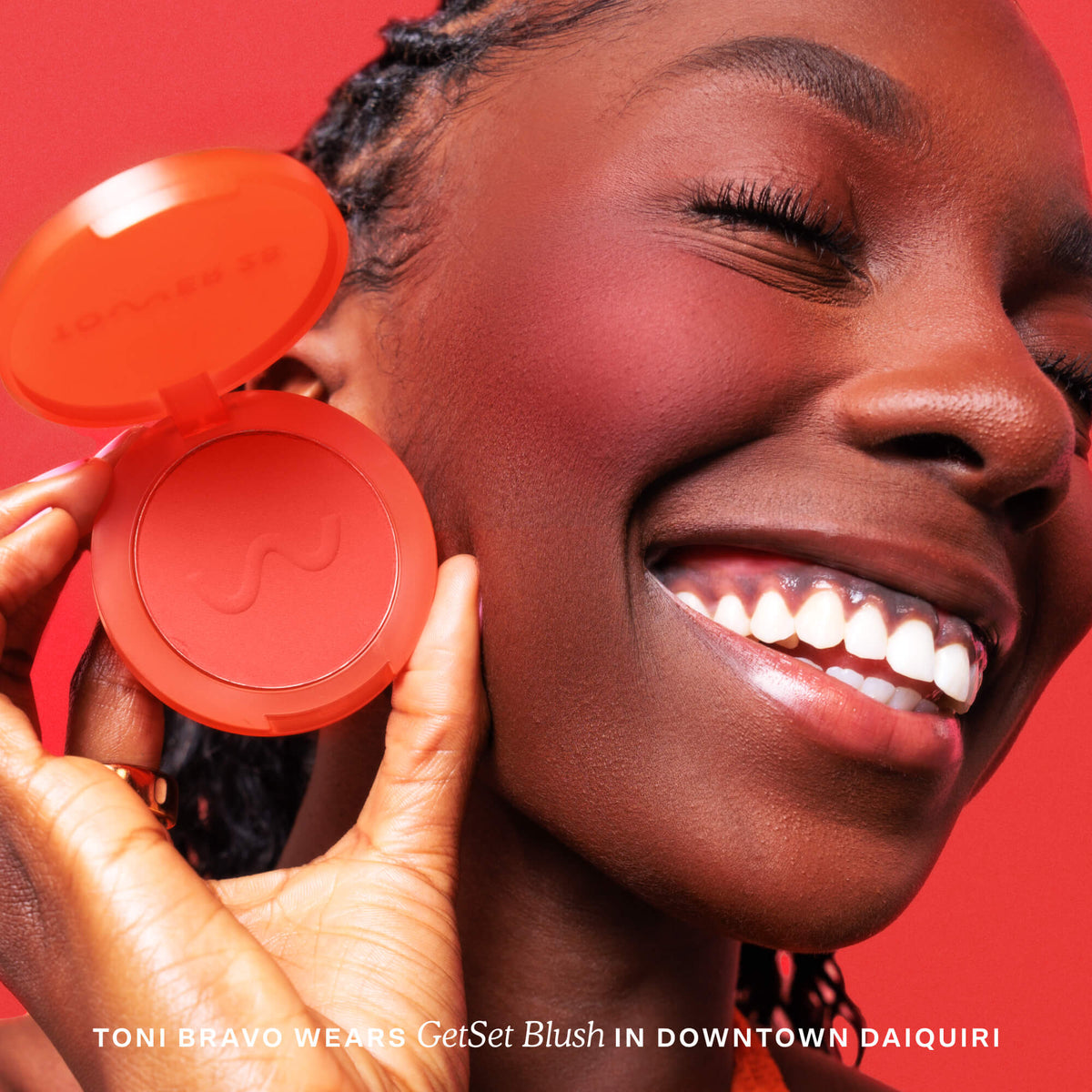 Woman holding a red blush compact with a red background [Downtown Daiquiri x Toni Bravo]