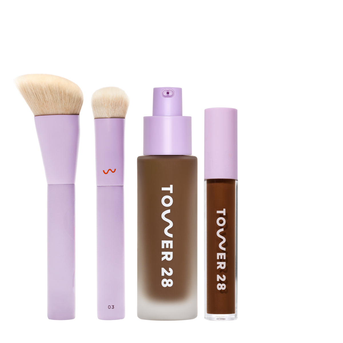 [shared] Tower 28 makeup set featuring a lavender brush, a lavender makeup brush with a small red logo, a frosted bottle of liquid foundation showing a brown shade, and a matching liquid lipstick in the brown shade, all on a white background.