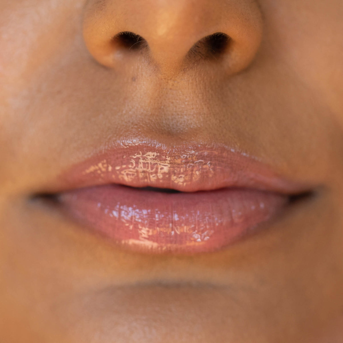 A model wearing the Tower 28 Beauty ShineOn Lip Jelly in the shade Pistachio on her lips. [Pistachio]