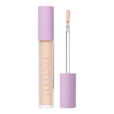 Tower 28 Beauty Swipe Serum Concealer in the shade 4.0 DTLA, shown with the tube standing upright next to the open applicator wand to reveal the product. [4.0 DTLA]