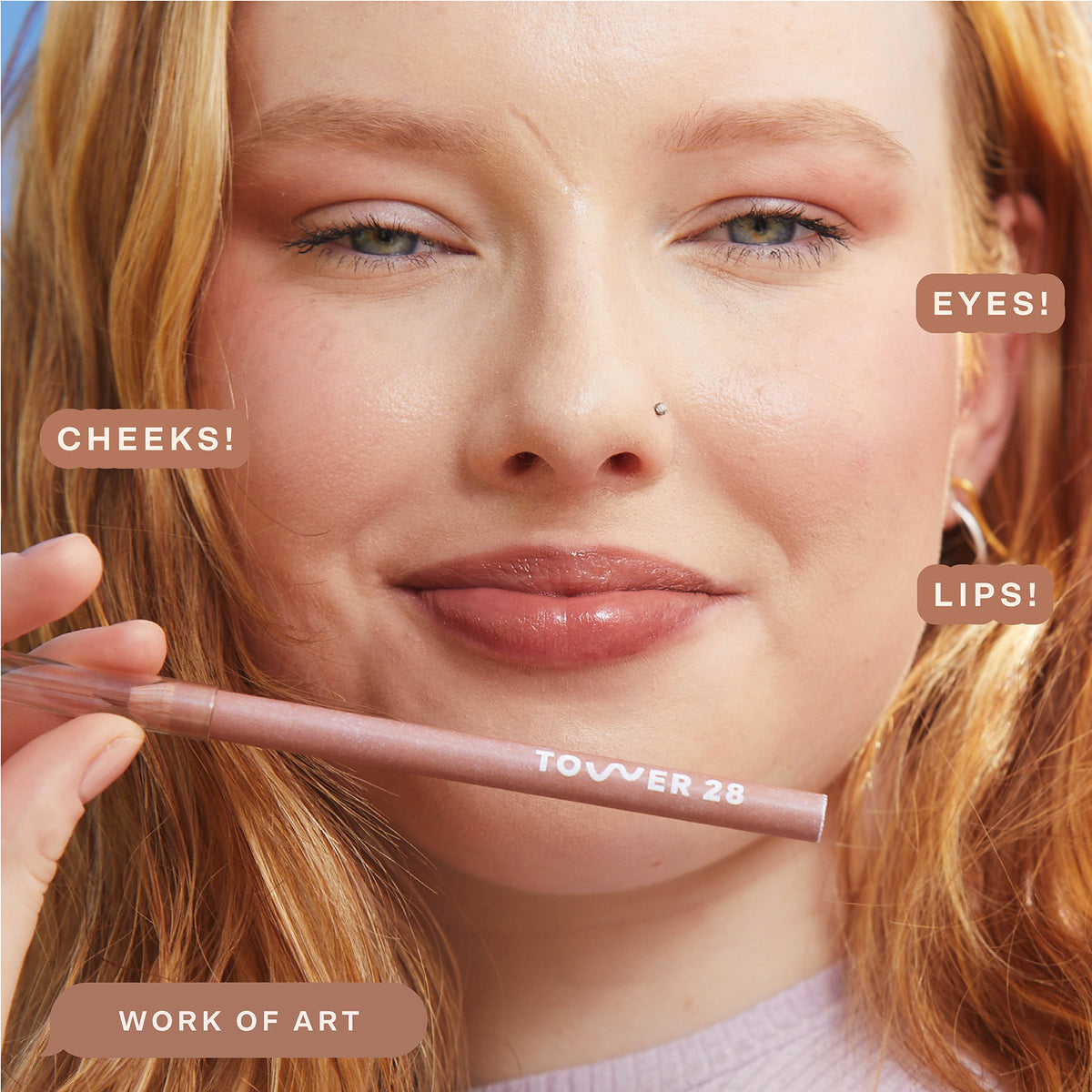 A person wearing the Tower 28 Beauty OneLiner in the shade Work of Art on her lips, cheeks, and eyes. [Work of Art]