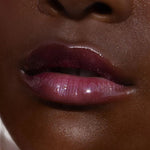 A model wearing the Tower 28 Beauty ShineOn Lip Jelly in the shade Fear Less on her lips. [Fear Less]